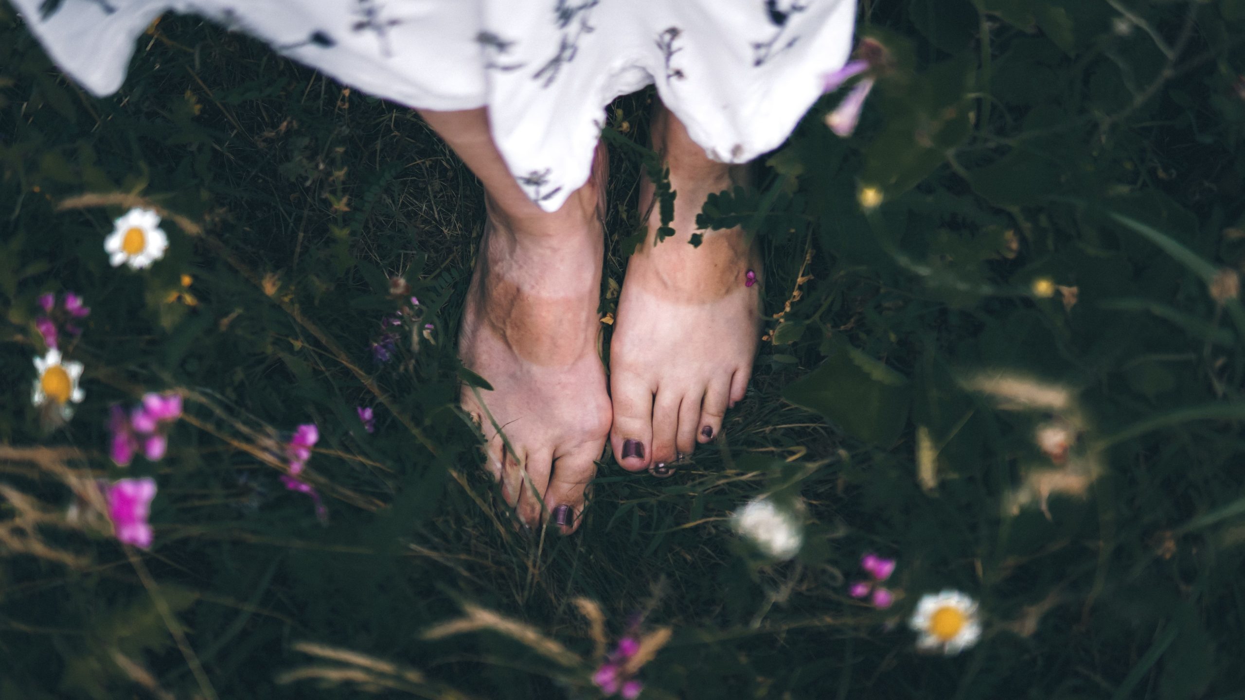 Pieds nus dans jardin fleuri verdoyant