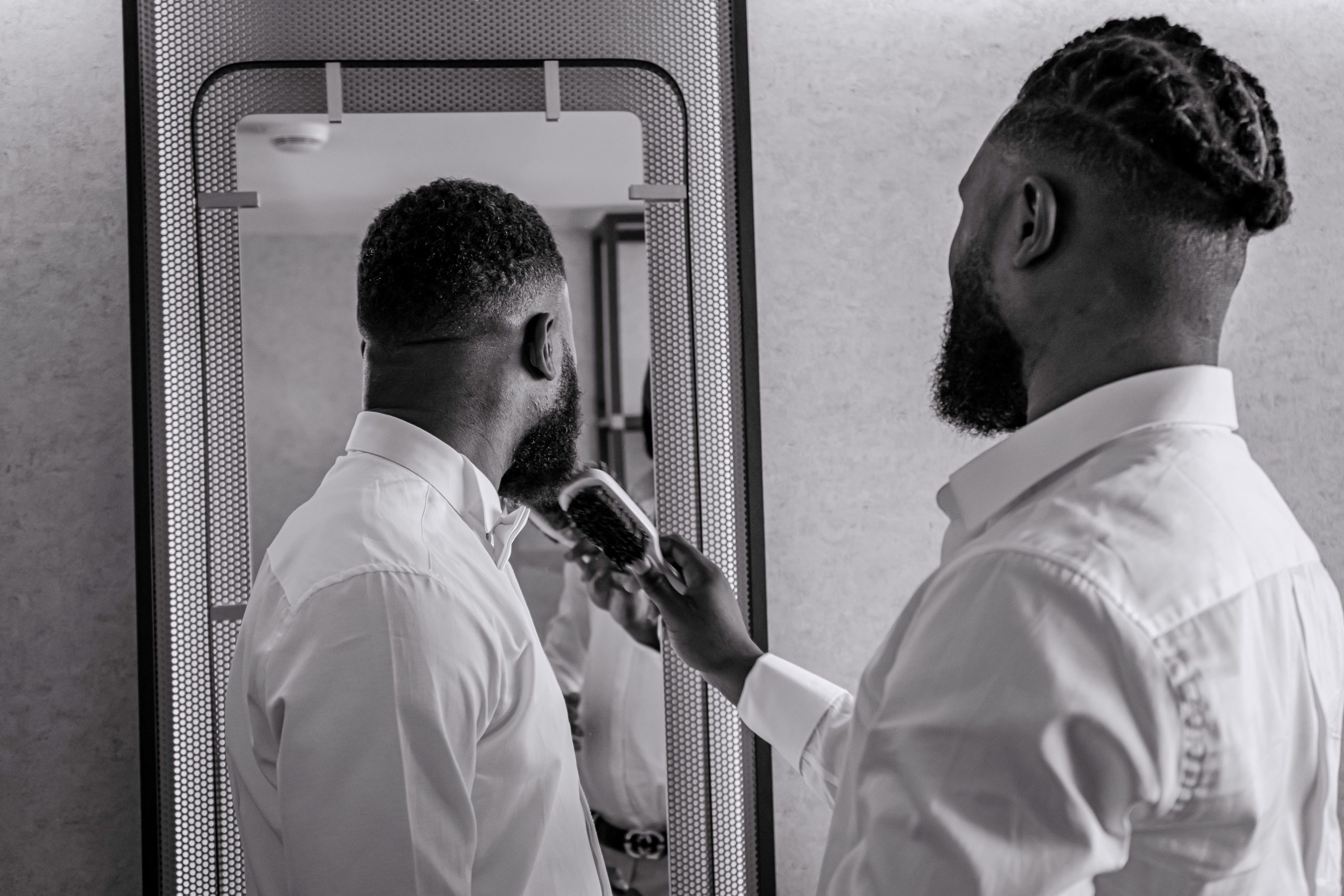 Homme brossant sa barbe devant miroir